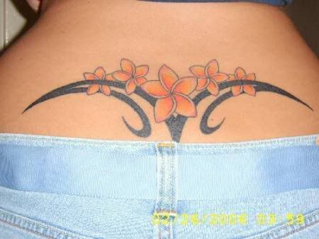 Flowers and tribal lower back tattoo
