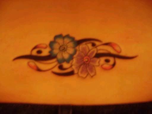 nice tribal flowers tattoo on lower back-950